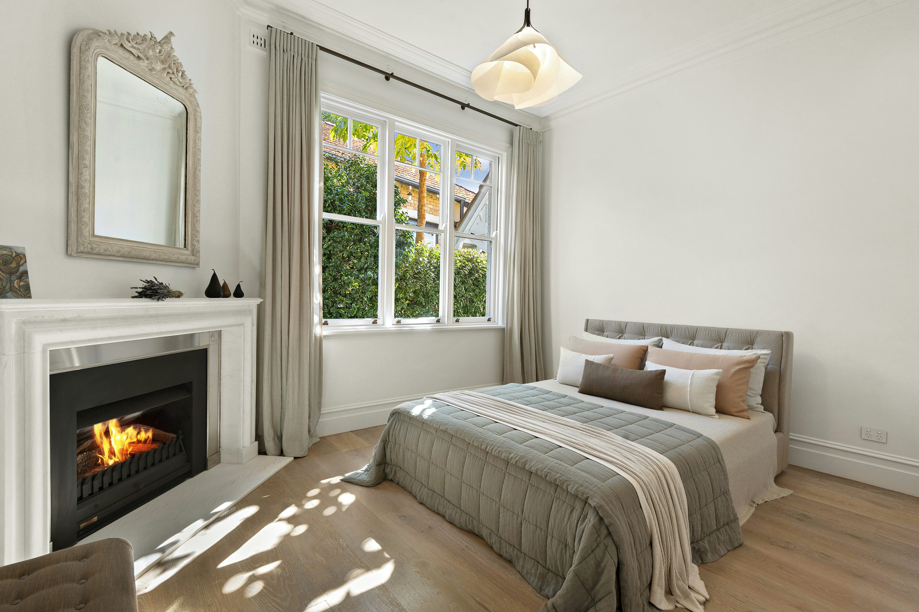 Cozy bedroom with natural light and perfectly made bed